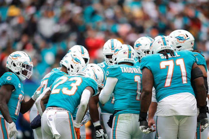 Dolphins players gather in a huddle